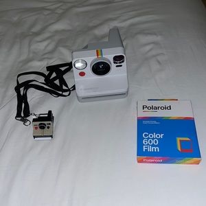 Brand new Polaroid Now camera, pack of colored film (comes with 8), charger